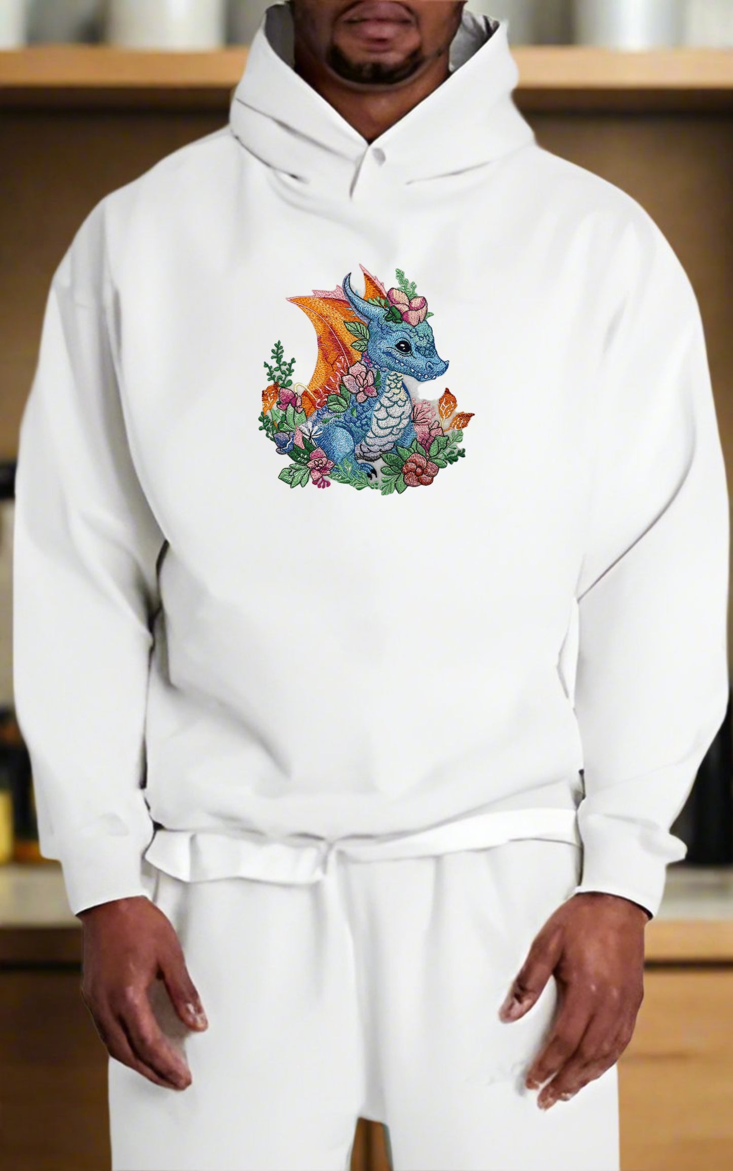 Embroidered hoodie featuring a mythical spring dragon with floral elements, in vibrant colors on a white background.