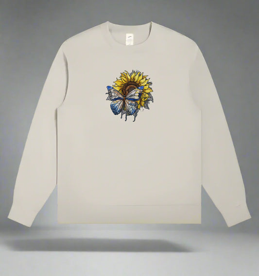 A detailed embroidery design of a sunflower with a butterfly, stitched in various colors on a mint green sweatshirt.
