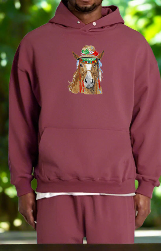 Maroon hoodie with a horse graphic on a blurred green background