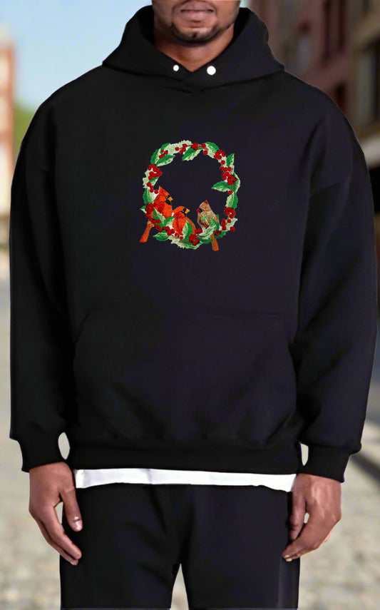 Embroidered design featuring two red cardinals among green foliage with red berries on a white background.