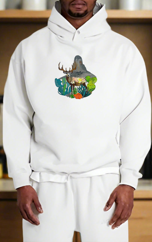 Embroidered hoodie featuring a mountain deer with a background of snow-capped mountains and greenery.