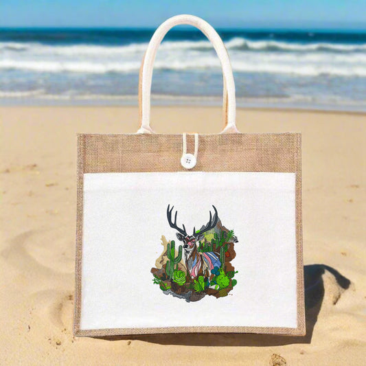 Embroidered jute tote bag featuring a mountain buck and cactus garden design.