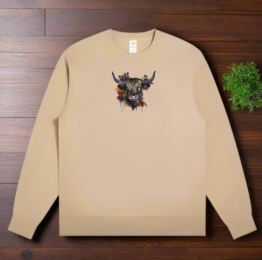 Beige sweatshirt with a decorative bull design on a wooden surface