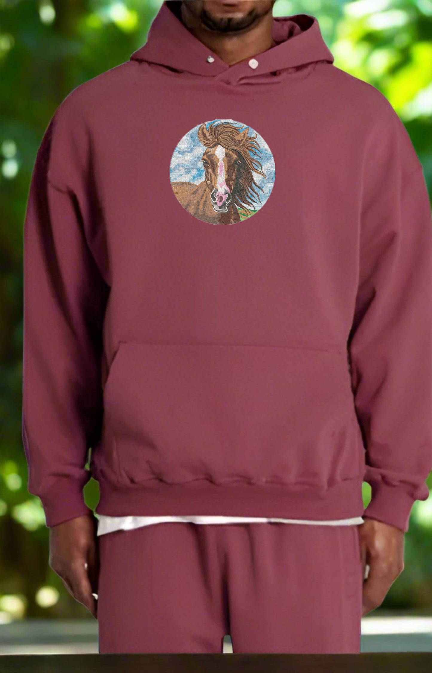 Embroidered hoodie featuring a majestic horse with a storm cloud in the background, highlighted by glow-in-the-dark raindrops and metallic lightning threads.