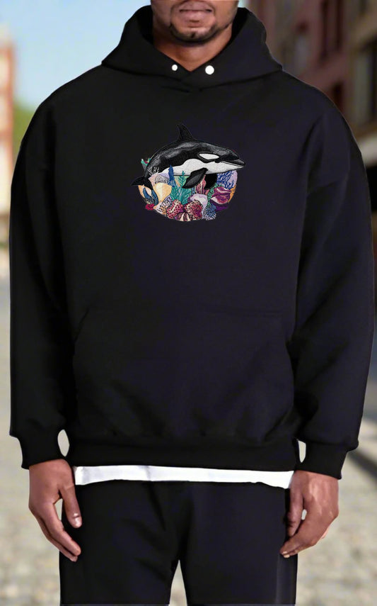 Person wearing a black hoodie with a colorful lip design on a blurred background