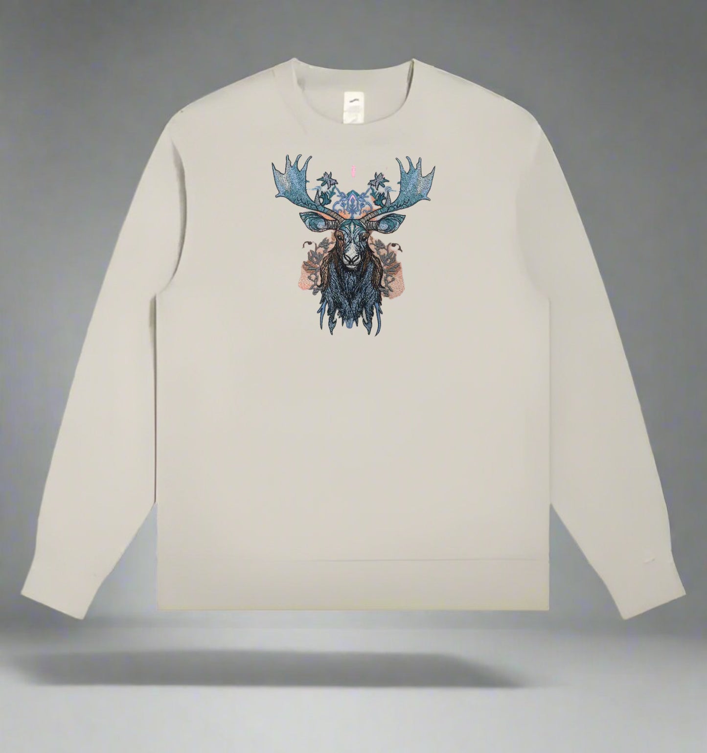 A stitched embroidery design of a moose head with ornate antlers and a floral pattern in blue, gray, and pink colors on a mint green sweatshirt background.