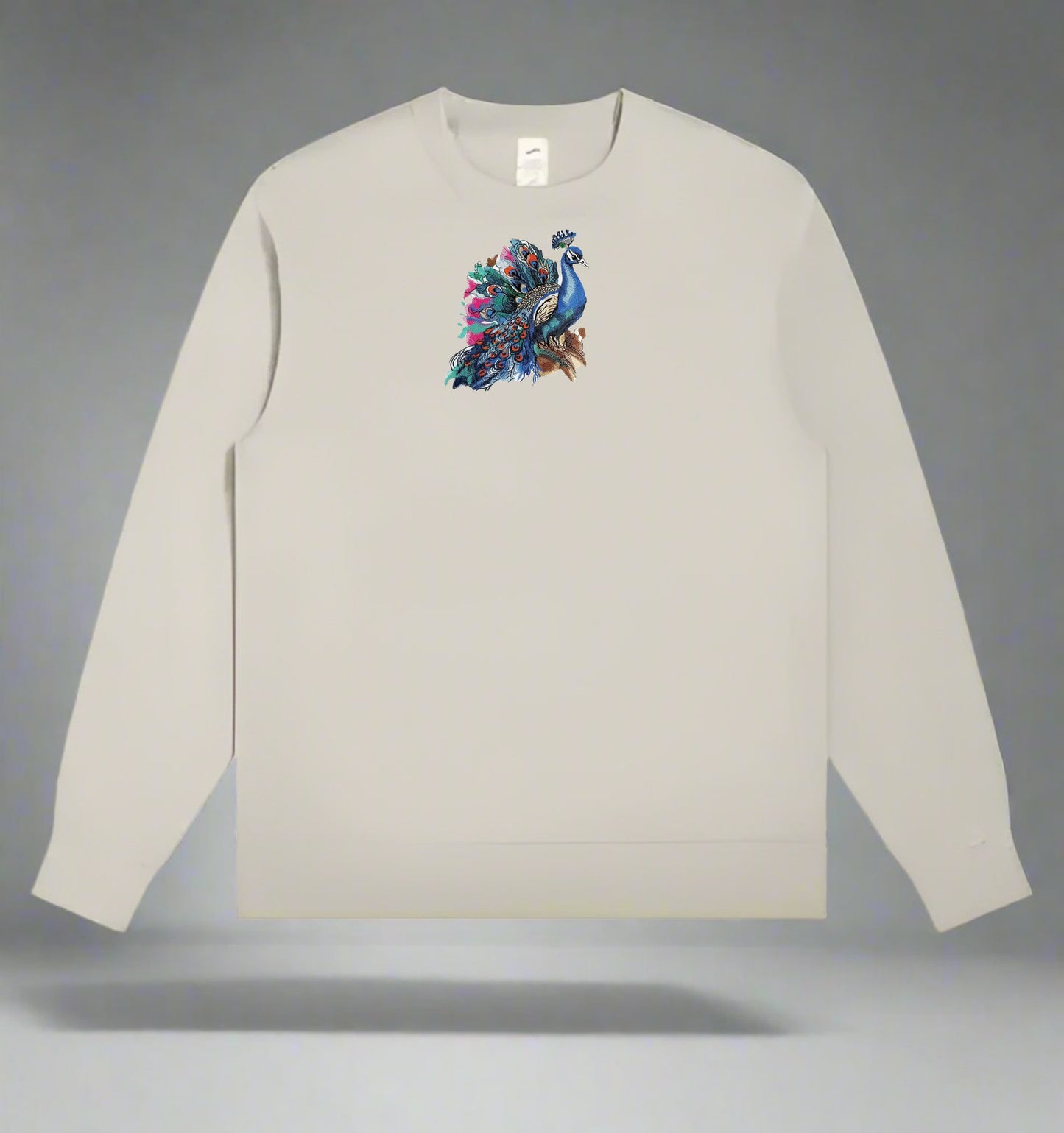 Mint green long-sleeve sweatshirt with a colorful peacock design on a gray background