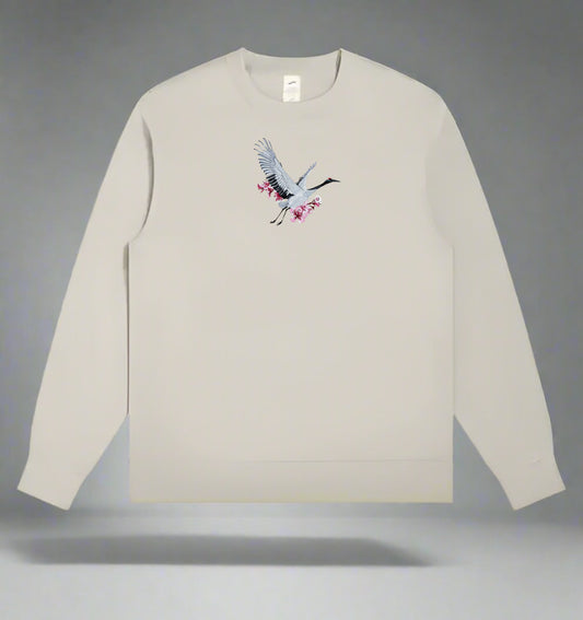 Mint green long-sleeve sweatshirt with a crane design on a gray background