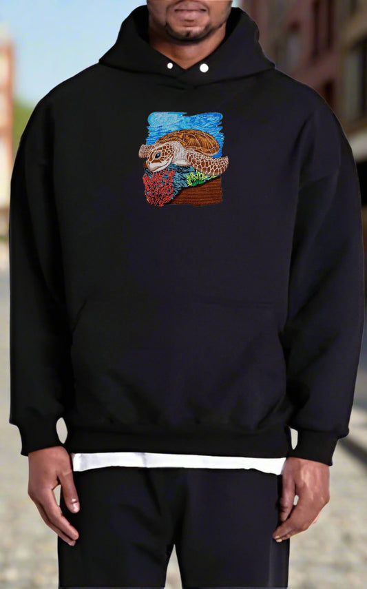 Person wearing a black hoodie with a colorful graphic design on a blurred background