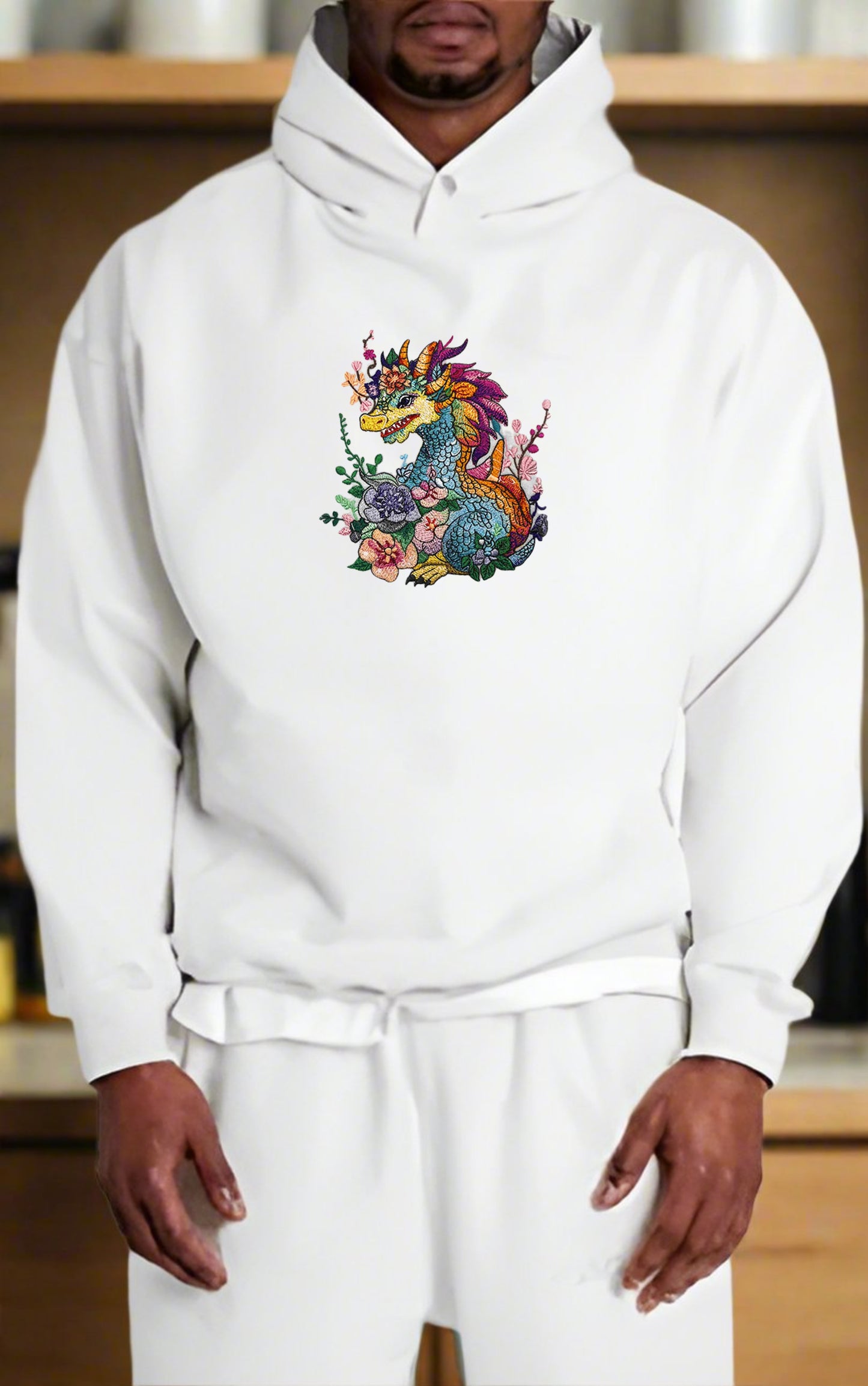 Embroidered hoodie featuring a colorful dragon surrounded by floral designs.