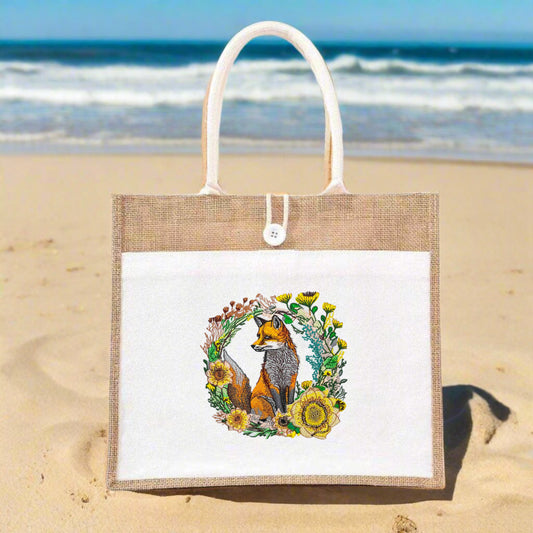 Embroidered jute tote bag featuring a fox surrounded by floral designs.