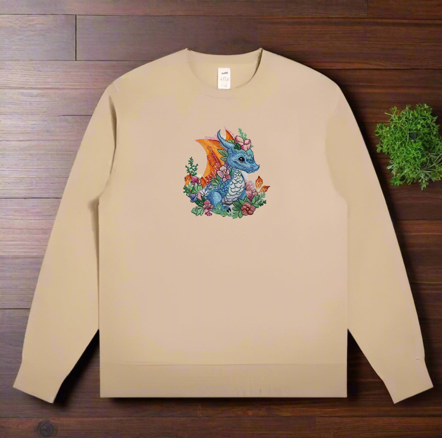 A colorful embroidery design of a dragon surrounded by floral elements and a detailed background.