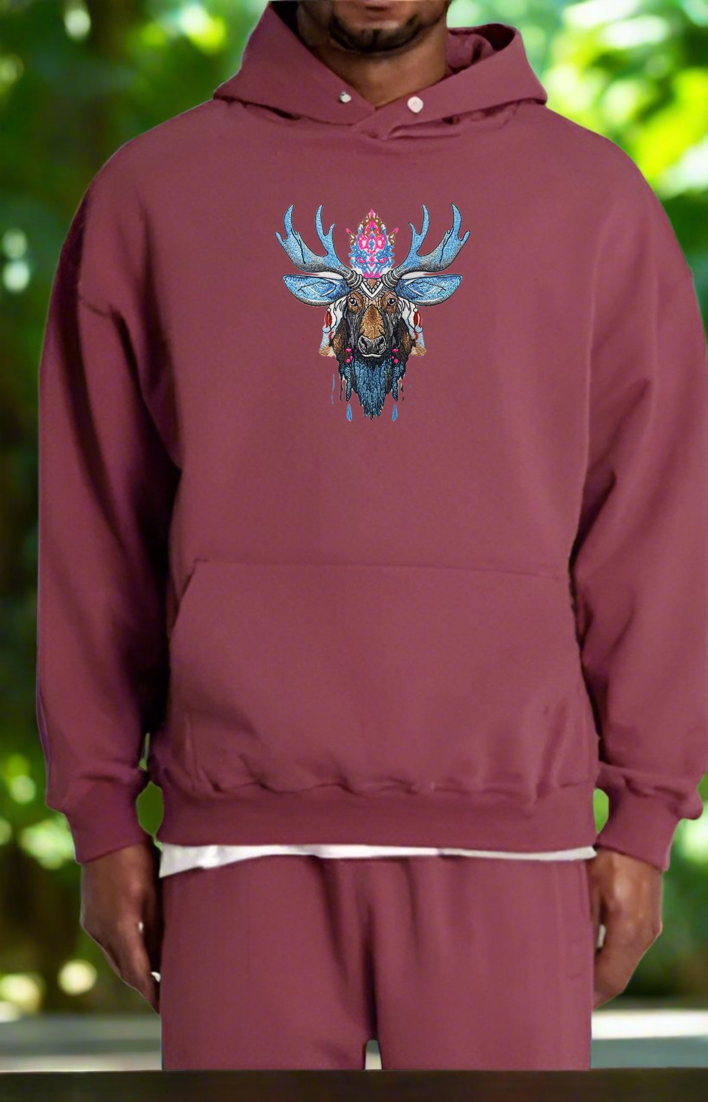 Embroidered hoodie featuring a detailed moose design with Nordic-inspired patterns, metallic gold and silver threads, and snowflake motifs.