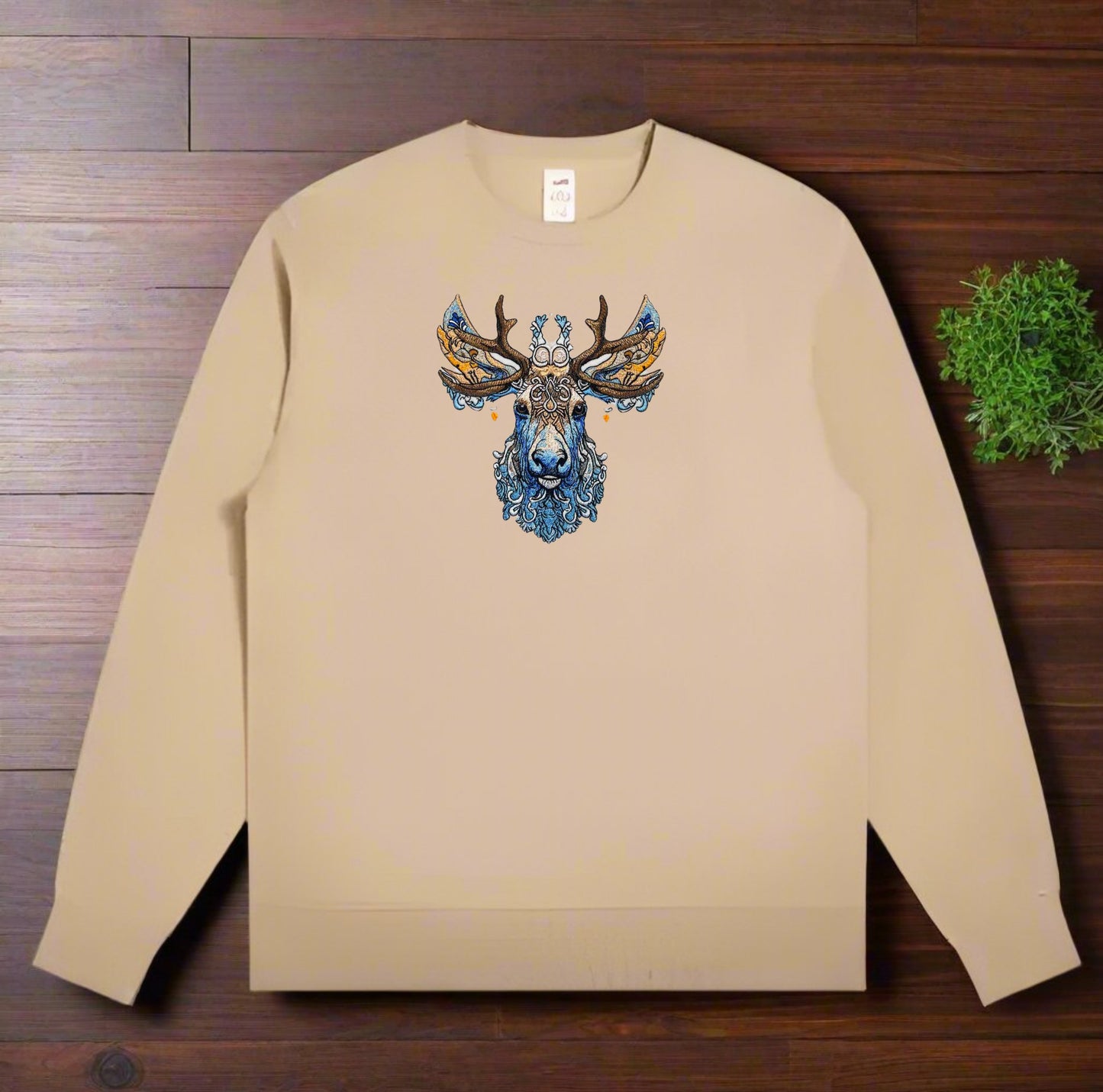 An embroidered image of a deer with intricate antlers and a detailed face featuring blue and brown colors.