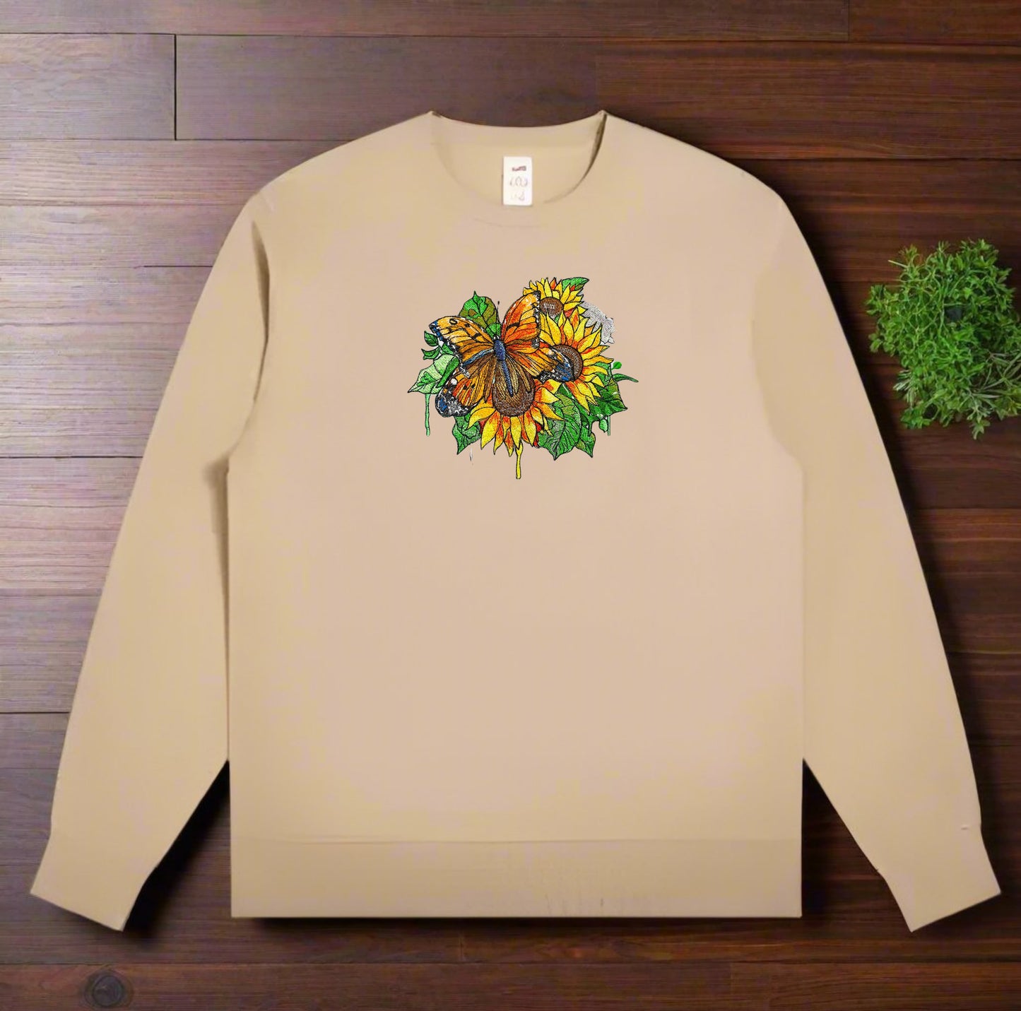 embroidered sweatshirt featuring a vibrant butterfly with detailed floral patterns on the front.