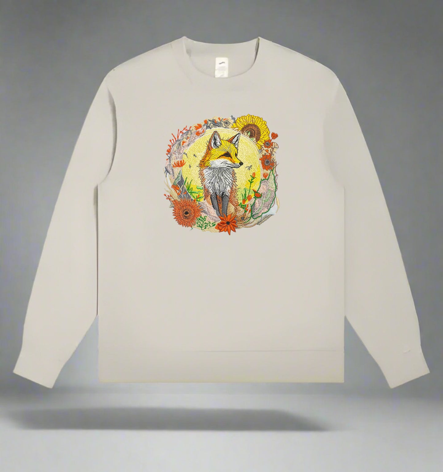 Embroidered crewneck sweatshirt with a design of a golden fox surrounded by floral patterns, predominantly in shades of yellow, green, and orange.