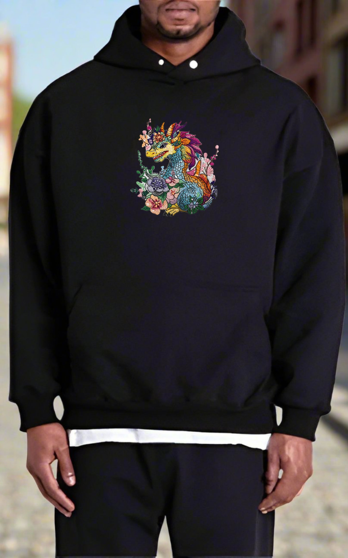 Embroidered hoodie featuring a colorful dragon surrounded by floral designs.