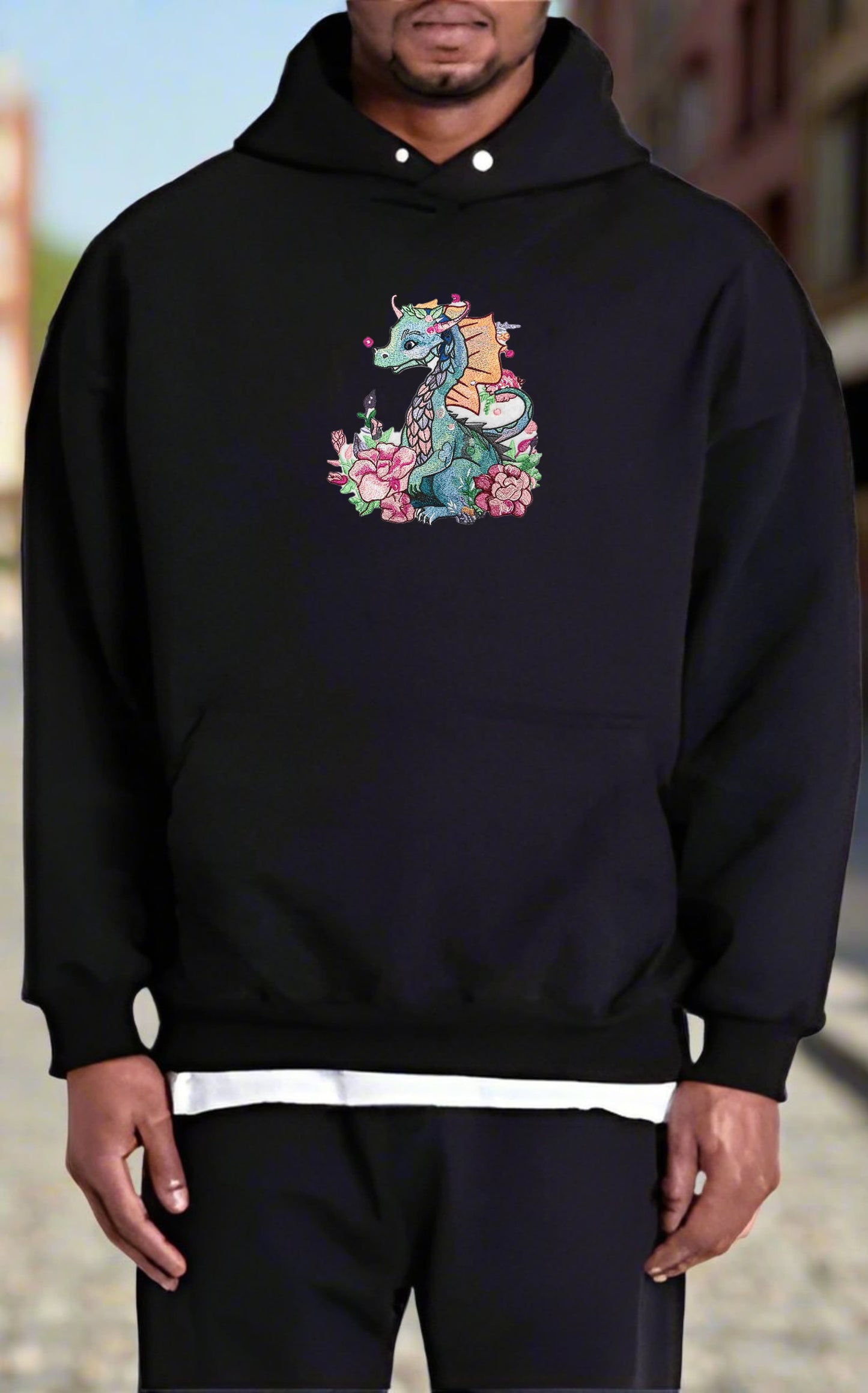 A vibrant, embroidered hoodie featuring a dragon with floral elements, surrounded by detailed embroidery of flowers.