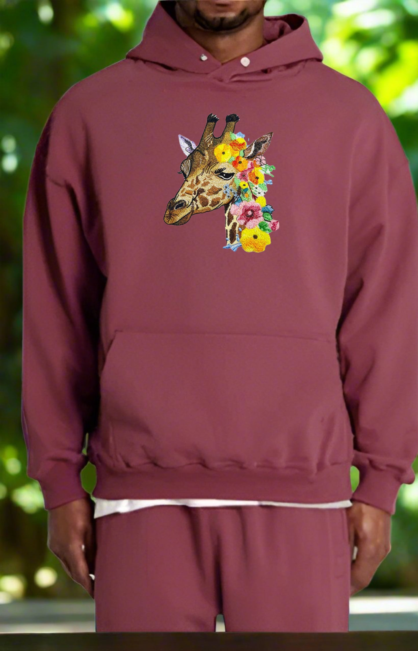 Embroidered hoodie featuring a giraffe with wildflower patterns.