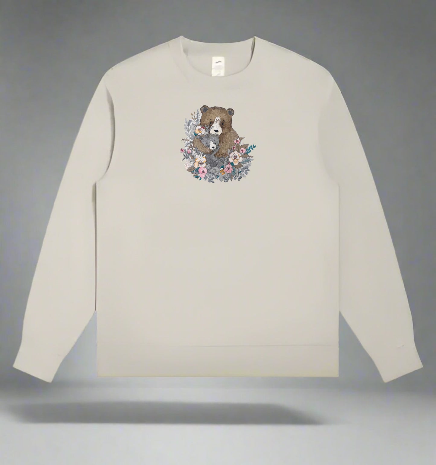 Mint green long-sleeve sweatshirt with a bear and floral design on a gray background