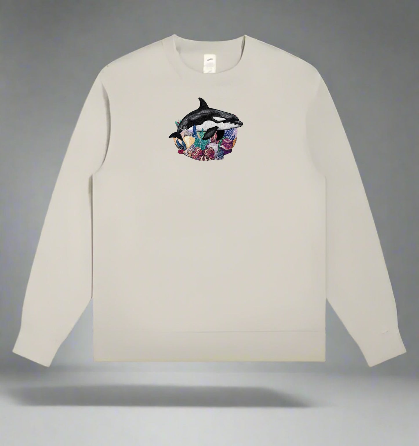 Mint green long-sleeve sweatshirt with a Orca Reef Garden Embroidery – Ocean Spirit of dolphins on a gray background