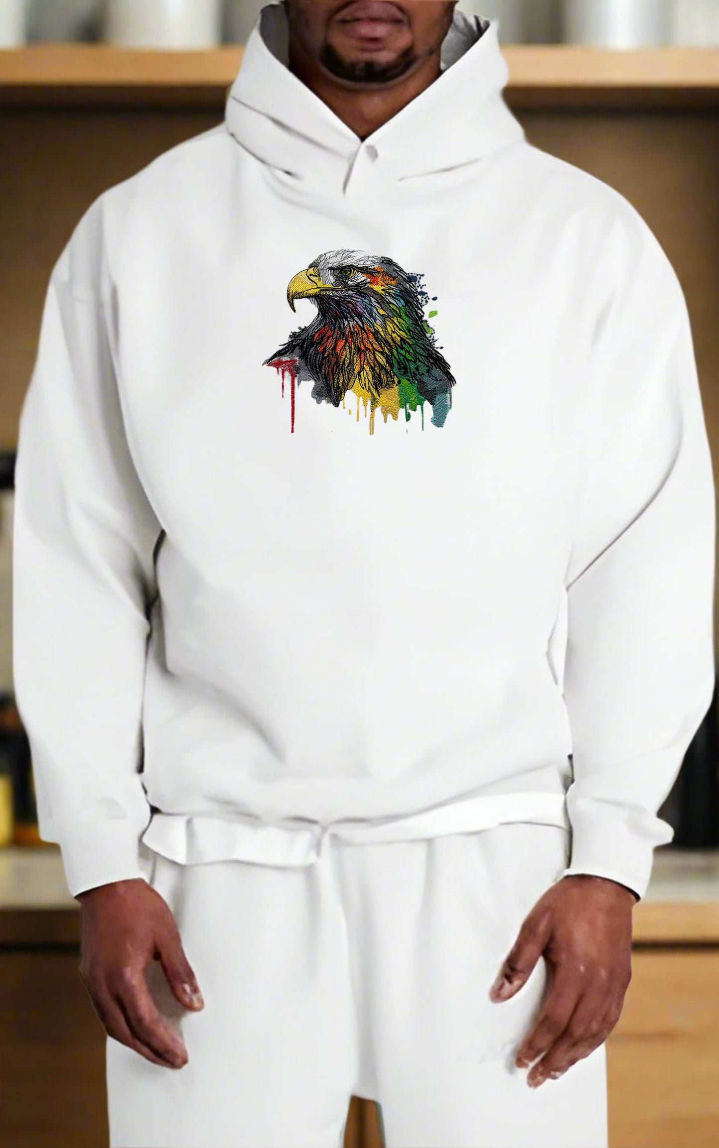Person wearing a white hoodie with a colorful eagle design.