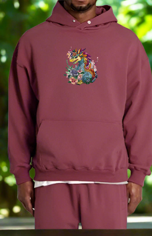 Embroidered hoodie featuring a colorful dragon surrounded by floral designs.