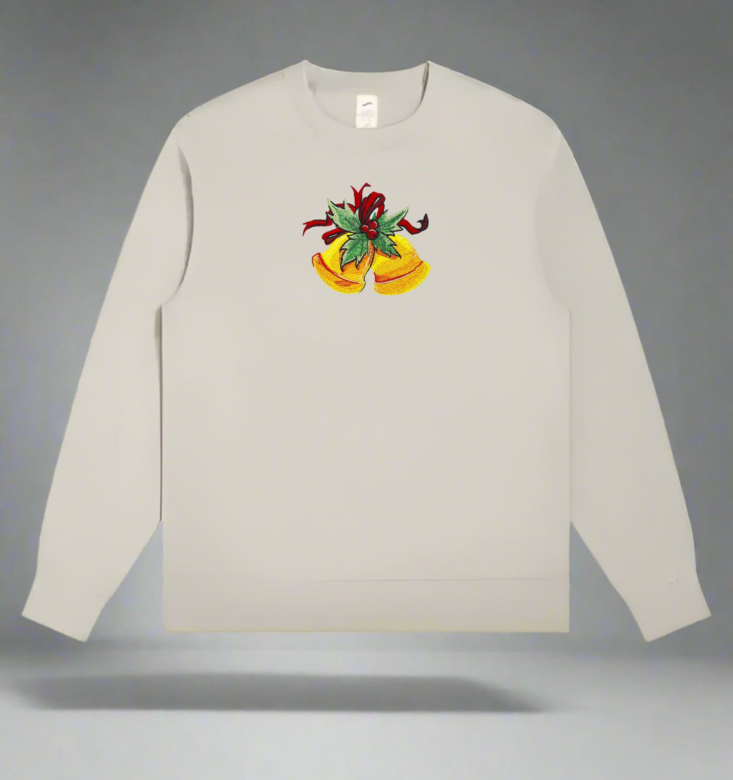 Light beige crewneck sweatshirt featuring embroidered golden Christmas bells with green holly leaves and a red ribbon centered on the chest.