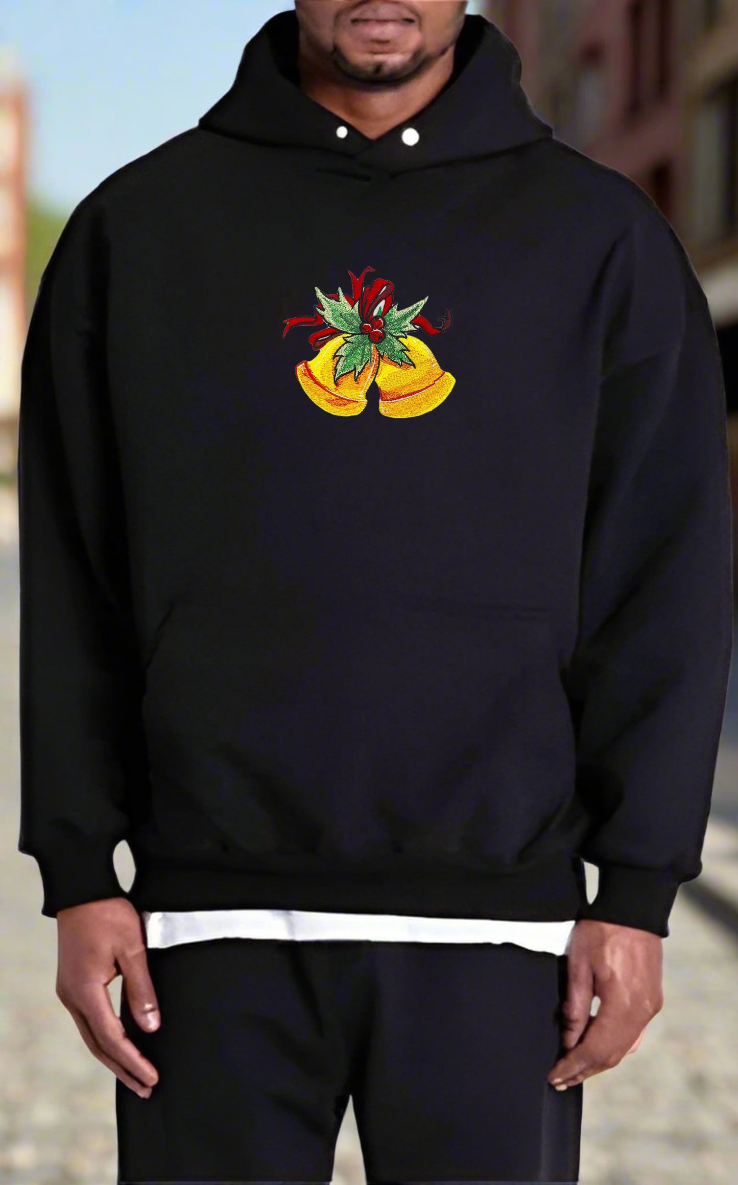 Black hoodie with embroidered golden bells adorned with holly leaves and a red ribbon on the front.