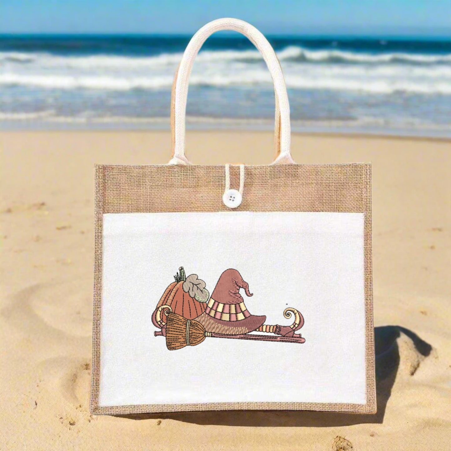 Jute bag with a design of fIf the Broom Fits Ride It Embroidery Design a on a beach