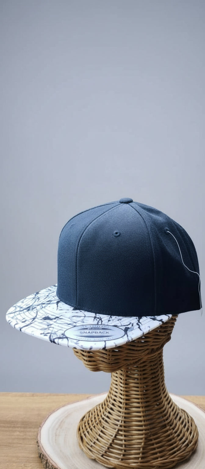 Blue cap with a white and blue patterned interior on a wicker stand.