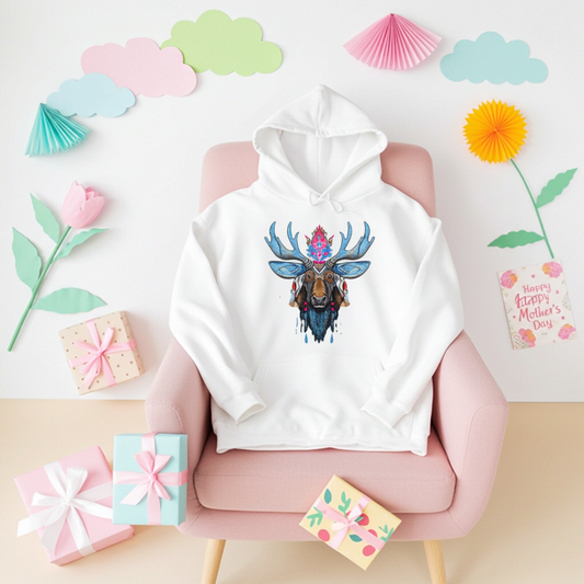 White premium hoodie with Mystic Crowned Moose embroidery featuring blue antlers and a jeweled crown, styled on a pink chair with pastel decor, gifts, and a Mother’s Day card, original EmbroMania artwork.