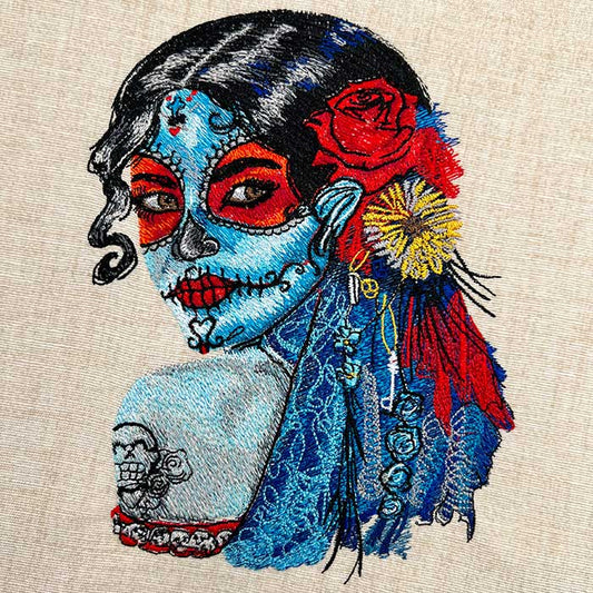 Embroidered design featuring a vibrant floral portrait of a woman with detailed petal designs and a few glow-in-the-dark elements.