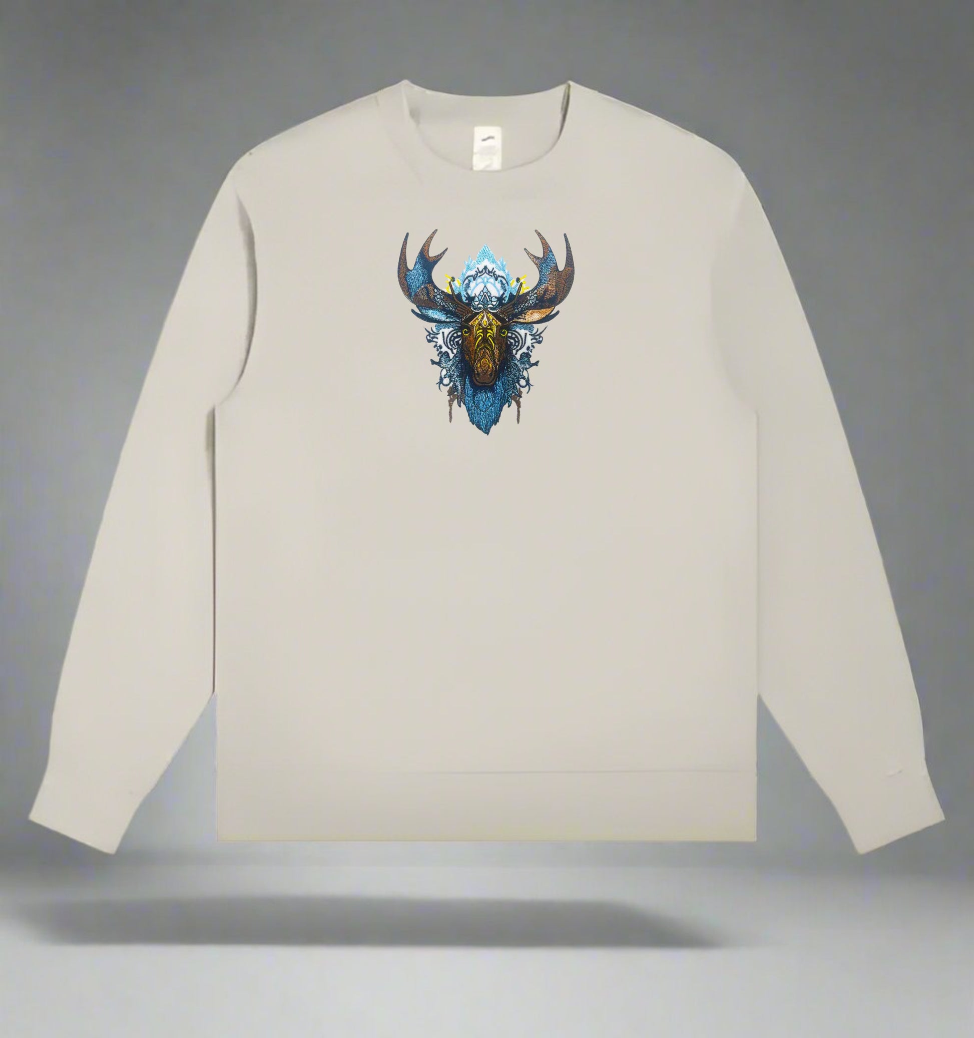 Embroidered sweatshirt featuring a tribal moose design with thread elements in blue and gold colors on a white background.