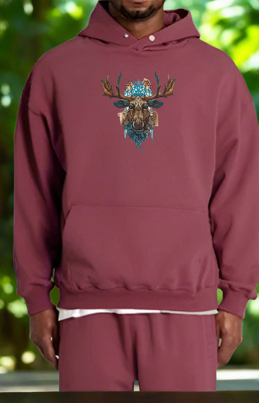 Embroidered hoodie featuring the head of a moose with antlers adorned with wild roses, lupines, and goldenrod against a beige background.