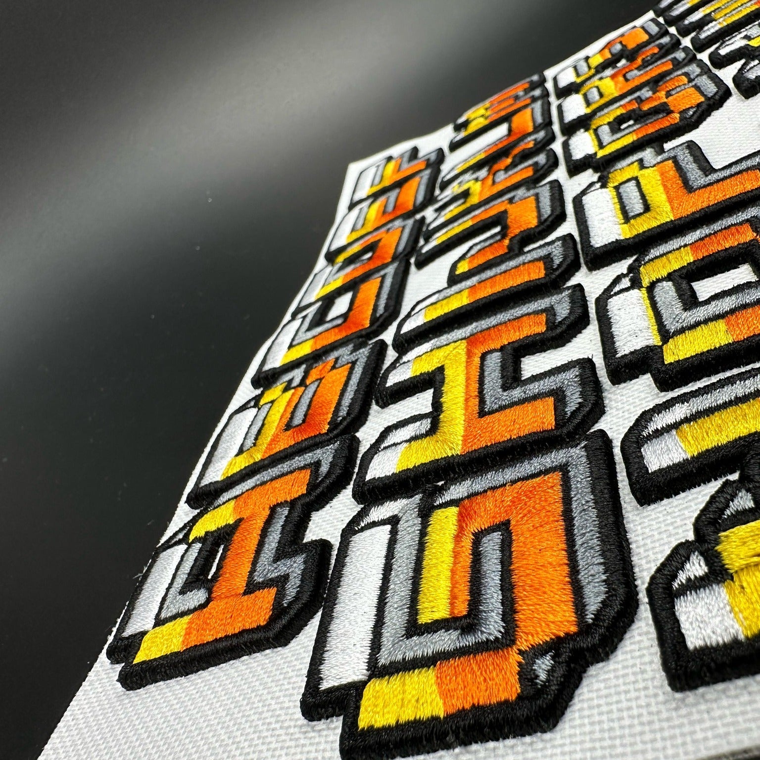 Set of geometric patterned patches on a gray background