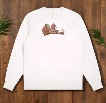White long-sleeve sweatshirt with  If the Broom Fits Ride It Embroidery Design on a wooden surface
