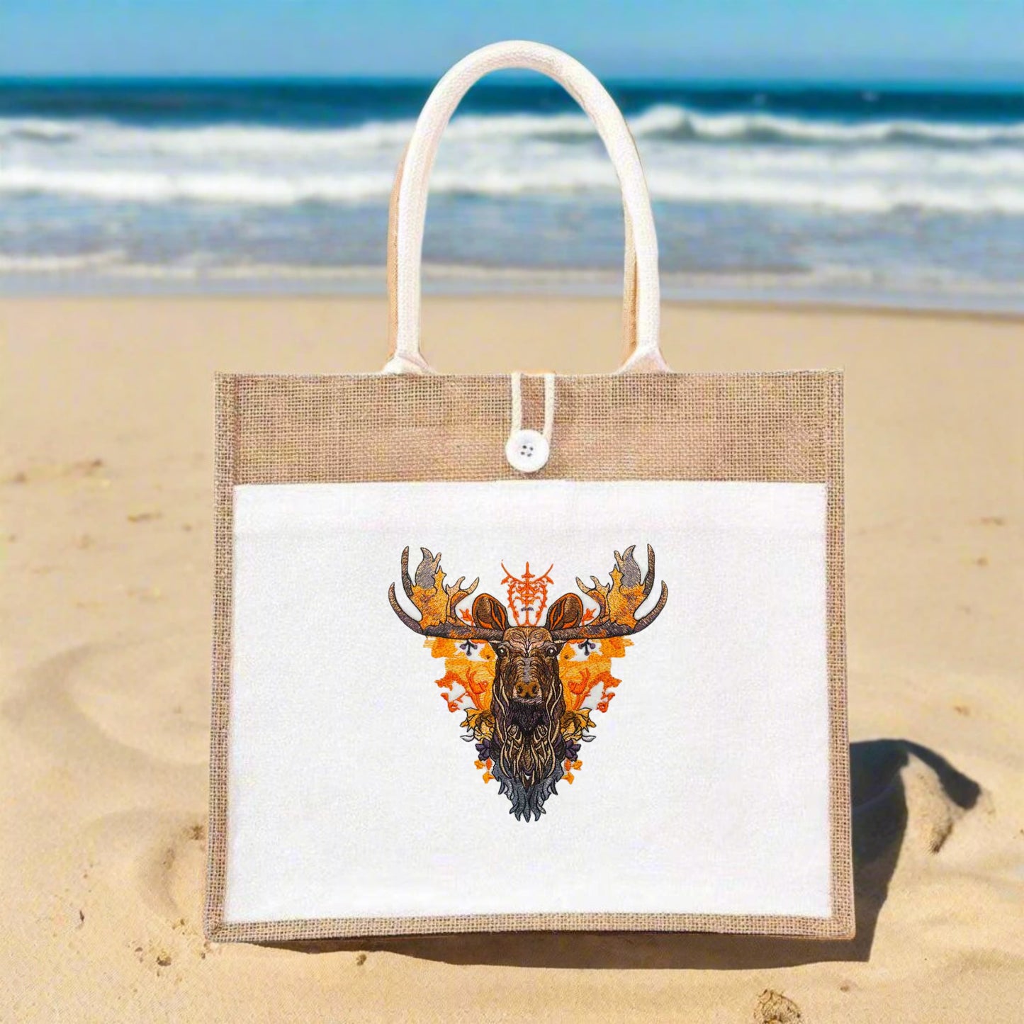 A tote bag with vibrant moose embroidery on the front, featuring a blend of brown, orange, and green colors.