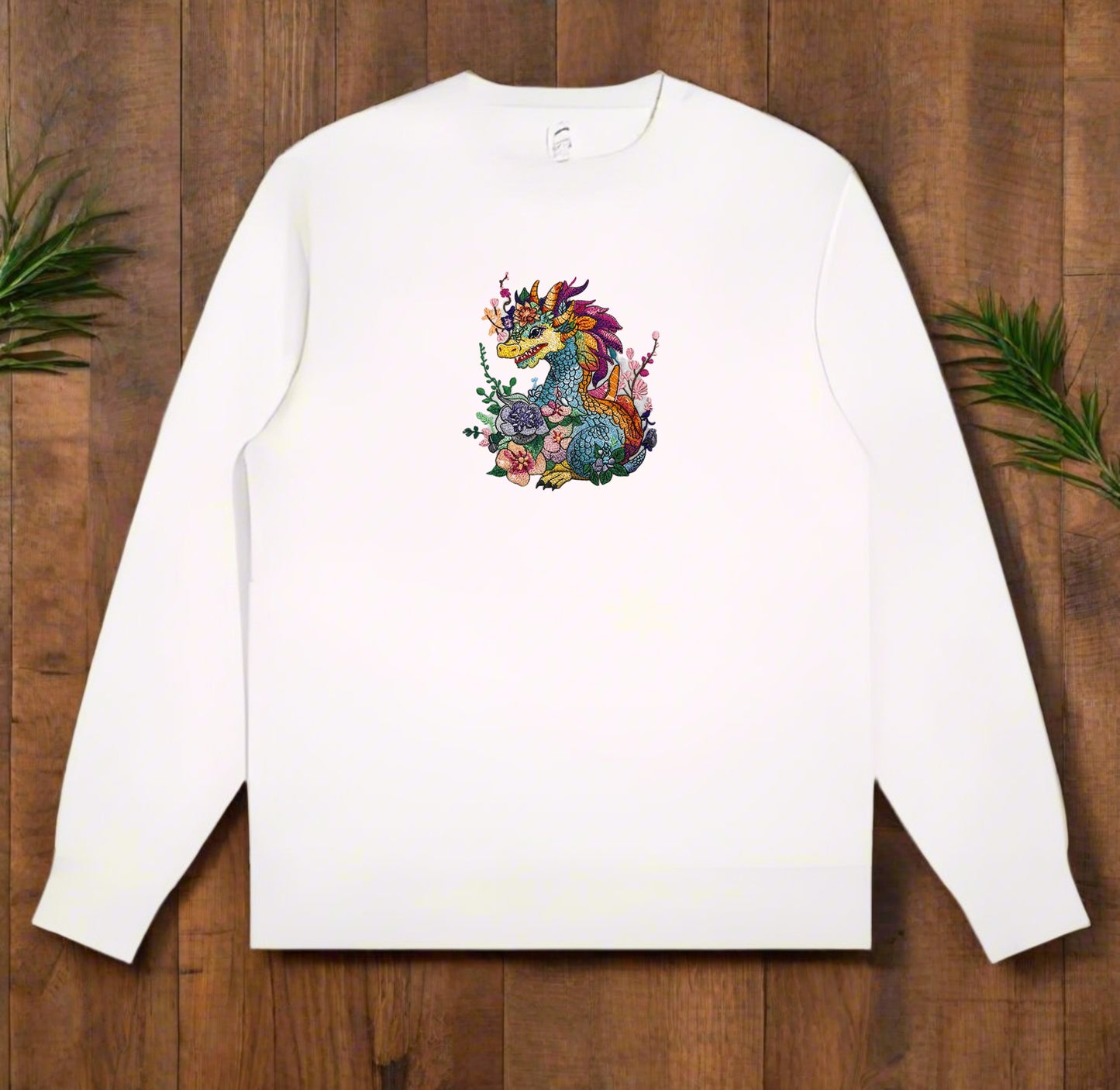A colorful embroidery design of a dragon with floral elements and a detailed mane and tail.