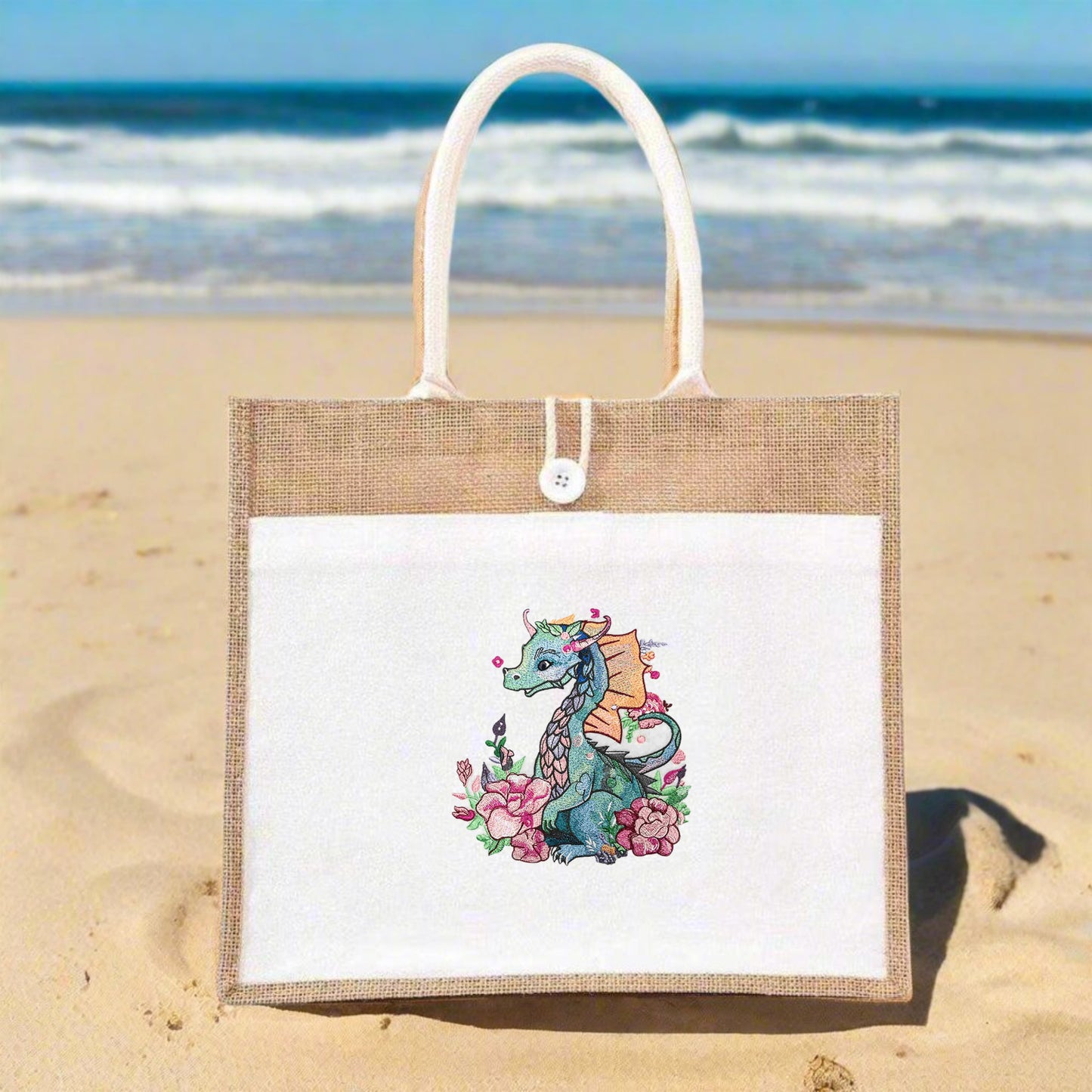 A tote bag made of jute with vibrant embroidery of a dragon surrounded by floral designs.