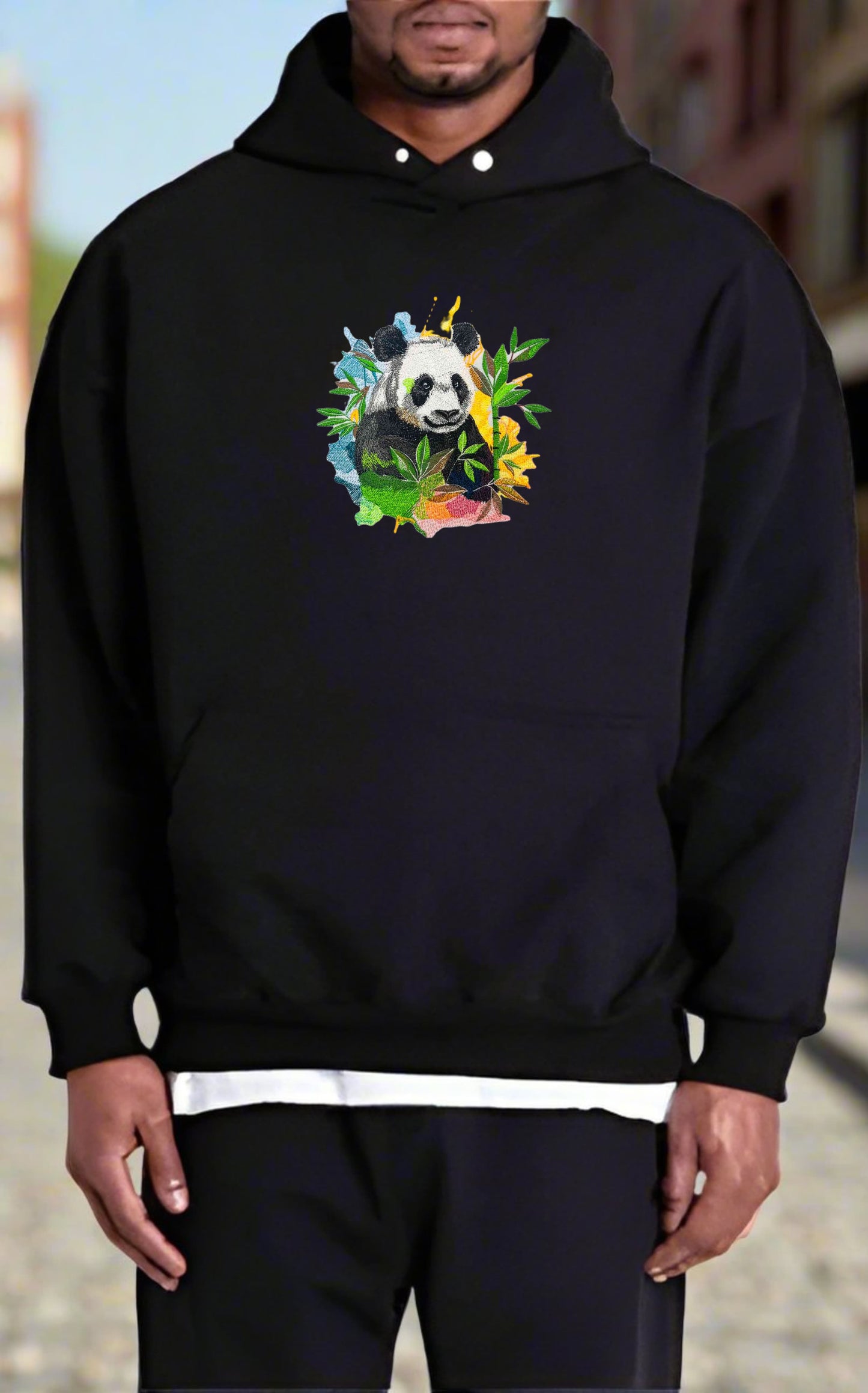 Person wearing a black hoodie with a colorful panda design.