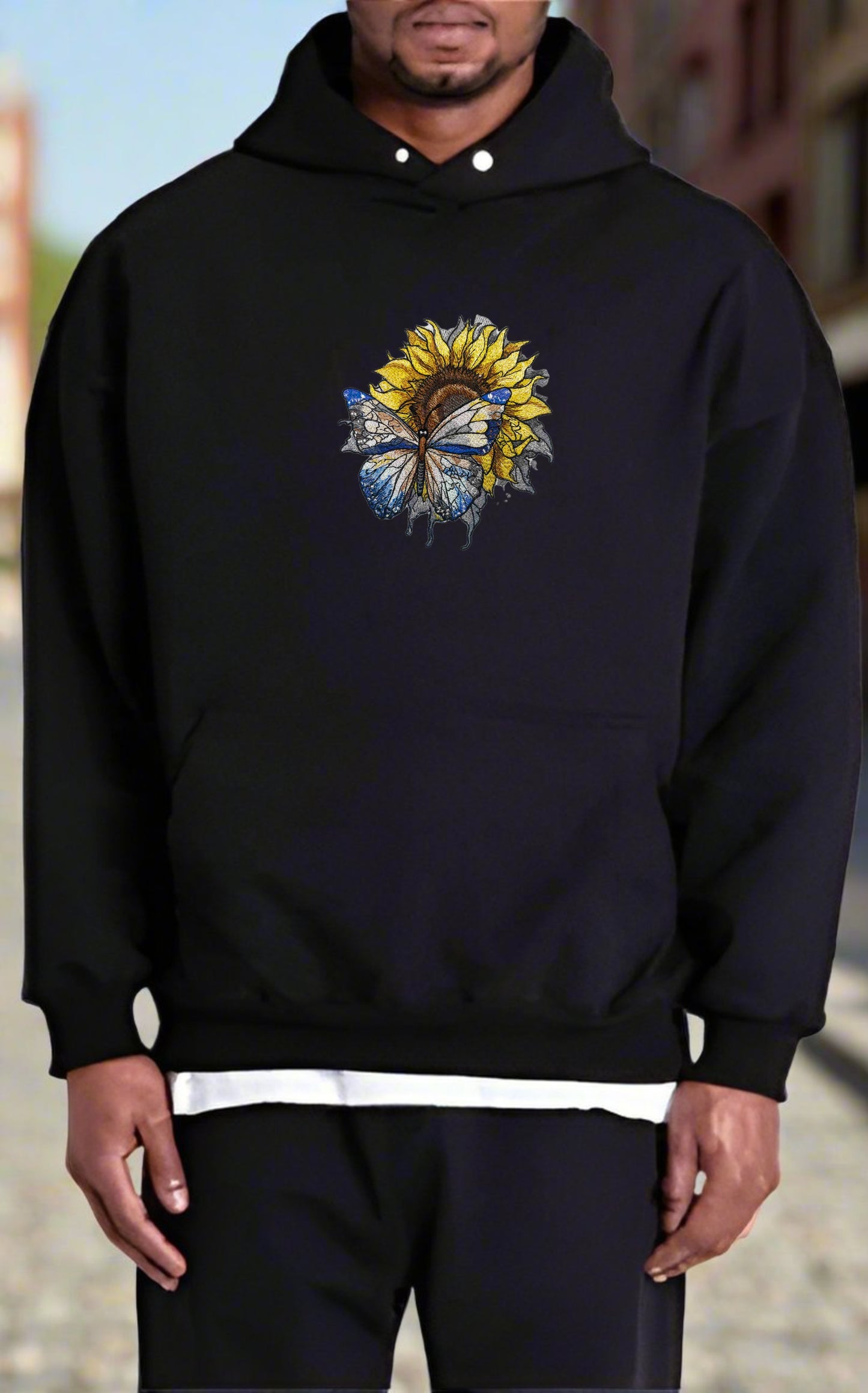 Embroidered sunflower and butterfly design on a hoodie