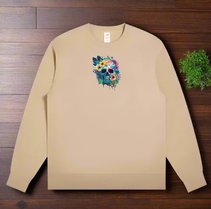 Beige sweatshirt with a colorful skull and flowers design on a wooden surface.