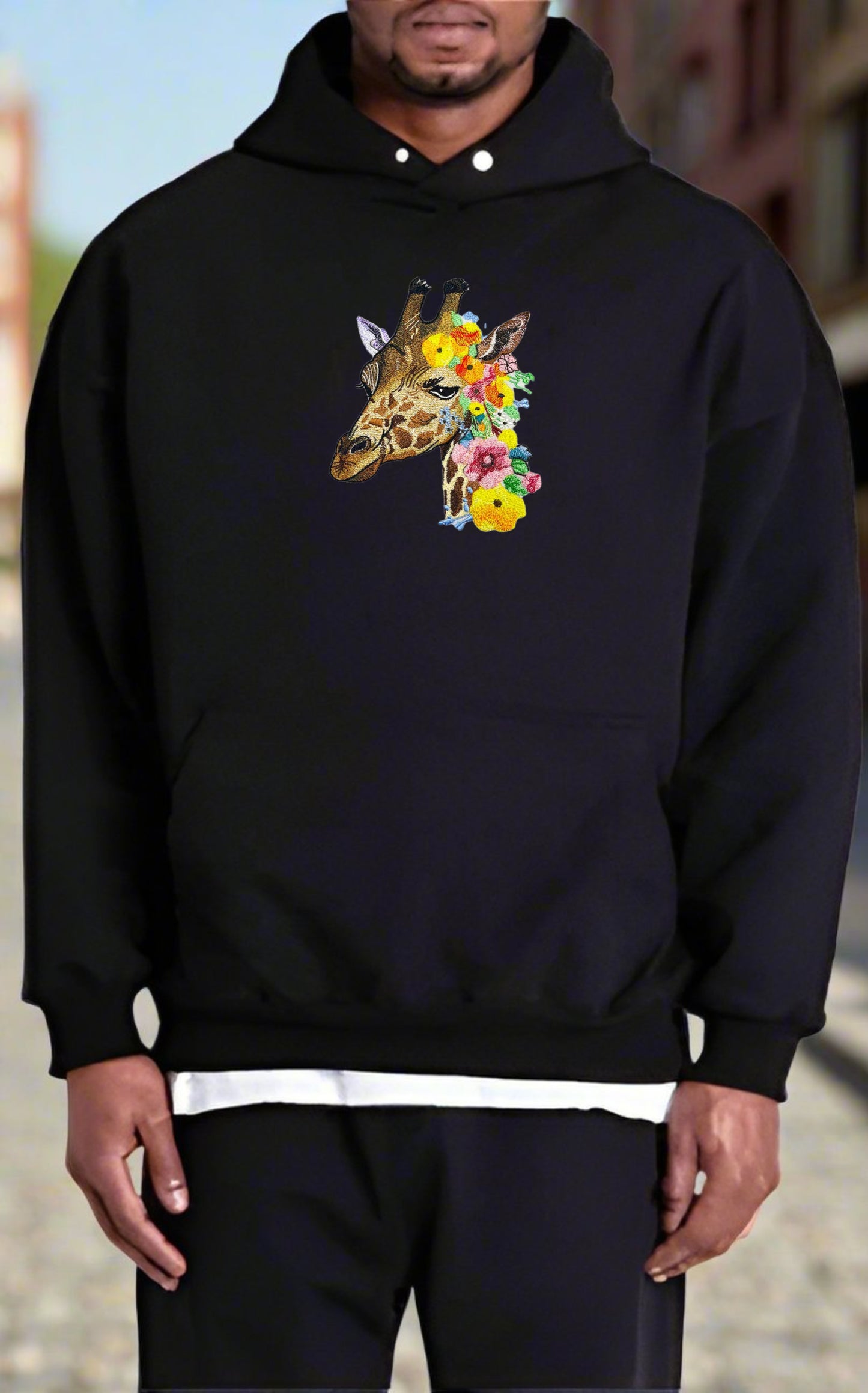 Embroidered hoodie featuring a giraffe with wildflower patterns.