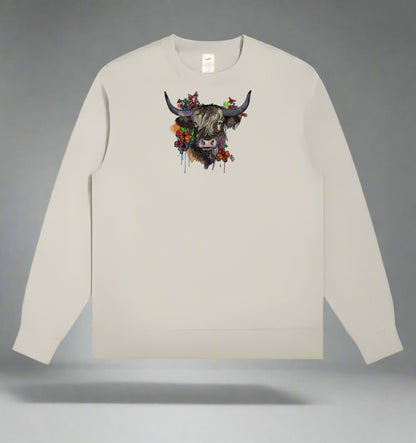 Beige long-sleeve sweatshirt with a colorful cow design on a gray background