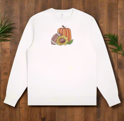 White long-sleeve sweatshirt with autumn-themed design on a wooden surface