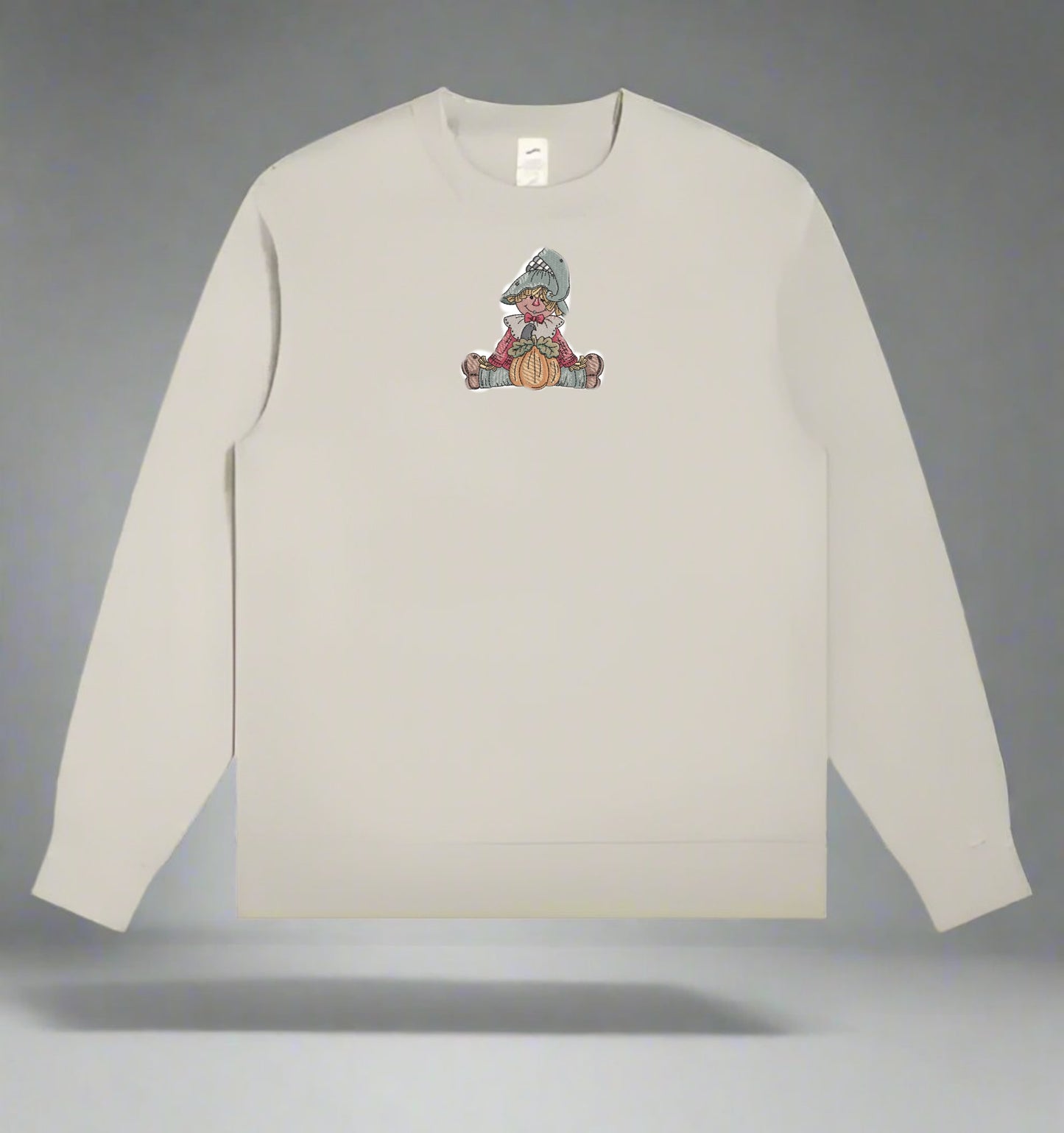 Mint Green  long-sleeve sweat shirt with a Scarecrow Pumpkin Embroidery Design on a gray background