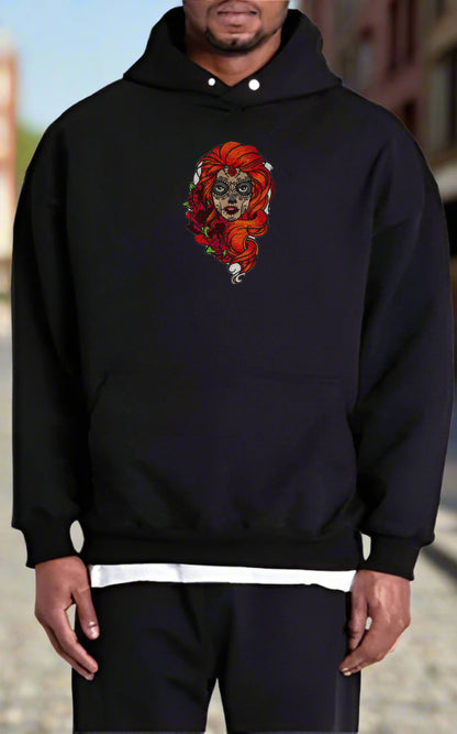 Person wearing a black hoodie with a  Sugar Skull Rose Girl Embroidery – Bold Artistic design on a blurred background