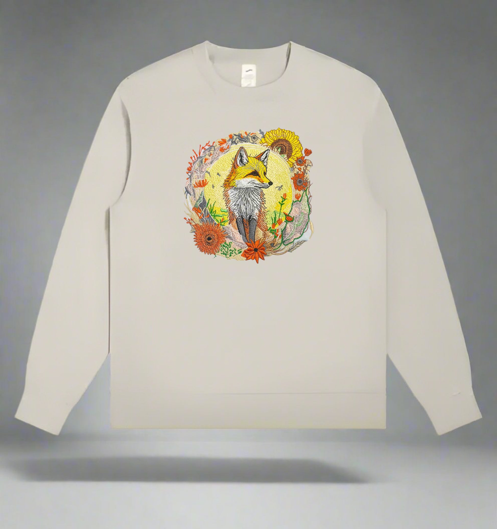 Embroidered crewneck sweatshirt with a design of a golden fox surrounded by floral patterns, predominantly in shades of yellow, green, and orange.