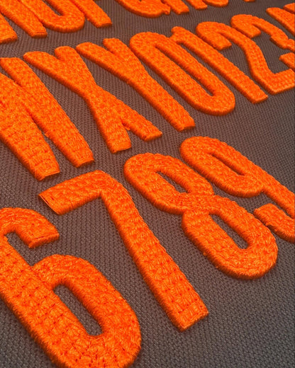 Close-up of orange numbers on a brown background